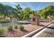 Community entrance signage in a neighborhood setting with trees and shrubs at 3875 E Claxton Ave, Gilbert, AZ 85297
