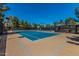 Well-maintained blue and brown tennis courts with black netting on a sunny day at 3875 E Claxton Ave, Gilbert, AZ 85297