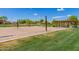 Community sand volleyball court featuring a shelter with picnic tables and mature landscaping at 3875 E Claxton Ave, Gilbert, AZ 85297