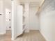 An organized walk-in closet with white shelving and neutral carpet providing ample storage space at 3875 E Claxton Ave, Gilbert, AZ 85297