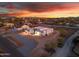 Stunning aerial view of modern home with flat roof at sunset, showcasing the property's layout and neighborhood at 475 W Saddle Mountain Rd, Phoenix, AZ 85086
