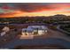 Panoramic aerial view showcasing modern home with clean lines, set against a vibrant sunset backdrop at 475 W Saddle Mountain Rd, Phoenix, AZ 85086