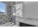 Modern bathroom with black fixtures, patterned tile surround, and a sleek vanity at 475 W Saddle Mountain Rd, Phoenix, AZ 85086