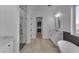Bright bathroom featuring marble counters, soaking tub, and modern walk-in shower at 475 W Saddle Mountain Rd, Phoenix, AZ 85086