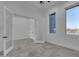 Bright bedroom features white walls, tile floors, and natural light from the windows at 475 W Saddle Mountain Rd, Phoenix, AZ 85086