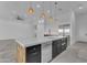 Close up of a kitchen island with a sink and seating, complemented by modern appliances at 475 W Saddle Mountain Rd, Phoenix, AZ 85086