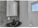 Well-lit powder room featuring a black sink and stylish dark-tiled wall at 475 W Saddle Mountain Rd, Phoenix, AZ 85086