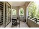 This balcony is spacious with gorgeous views of the greenery and a comfortable chair for lounging at 5345 E Van Buren St # 209, Phoenix, AZ 85008