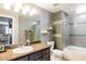 This bathroom features a tiled shower, modern vanity, and excellent natural lighting at 5345 E Van Buren St # 209, Phoenix, AZ 85008