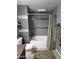 This bathroom offers a tiled shower and tub combination, perfect for relaxation and cleanliness at 5345 E Van Buren St # 209, Phoenix, AZ 85008