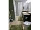 This bathroom includes a vanity, toilet, and tile floors and is painted grey for a modern look at 5345 E Van Buren St # 209, Phoenix, AZ 85008