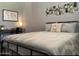 Serene bedroom featuring a comfortable bed, modern decor, and a functional workspace at 5345 E Van Buren St # 209, Phoenix, AZ 85008