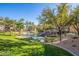 Scenic condo community features a well-manicured lawn with a picturesque pond and mature trees at 5345 E Van Buren St # 209, Phoenix, AZ 85008