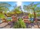 Gorgeous community pool featuring vibrant flowers, swaying palms and a pergola for shade at 5345 E Van Buren St # 209, Phoenix, AZ 85008