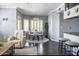 Open-concept dining room with a round table, stylish chairs, and natural light from plantation-shuttered windows at 5345 E Van Buren St # 209, Phoenix, AZ 85008