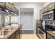 Modern kitchen featuring stainless steel appliances, a double sink, and sleek granite countertops at 5345 E Van Buren St # 209, Phoenix, AZ 85008