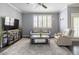 Comfortable living room with a neutral color scheme, large window with shutters, and contemporary decor at 5345 E Van Buren St # 209, Phoenix, AZ 85008