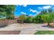 View of the home's sports court, complete with a basketball hoop, surrounded by mature landscaping at 5787 W Barbara Ave, Glendale, AZ 85302