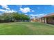 Expansive backyard featuring a pool, slide, and lush green lawn, perfect for outdoor activities and relaxation at 5787 W Barbara Ave, Glendale, AZ 85302