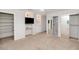 Spacious bedroom with custom built-ins, neutral carpet, ceiling fan, and sliding closet doors at 5787 W Barbara Ave, Glendale, AZ 85302