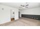 Bedroom with ceiling fan, neutral carpet, two-tone paint, plus an ensuite bathroom with wood-look flooring at 5787 W Barbara Ave, Glendale, AZ 85302