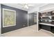 Bedroom featuring built-in shelving, mirrored closet doors, ceiling fan, and a window allowing natural light at 5787 W Barbara Ave, Glendale, AZ 85302