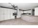 Modern kitchen featuring granite countertops, white cabinetry, and an open design to the living area at 5787 W Barbara Ave, Glendale, AZ 85302