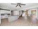 Expansive living area seamlessly connecting the kitchen with hardwood look floors and stylish ceiling fans at 5787 W Barbara Ave, Glendale, AZ 85302