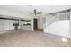 Spacious open living area with hardwood look floors, stylish ceiling fan, and a staircase leading upstairs at 5787 W Barbara Ave, Glendale, AZ 85302