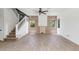 Stylish living room with hardwood look floors, decorative ceiling fan, and a staircase to the second floor at 5787 W Barbara Ave, Glendale, AZ 85302