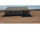 Rear exterior featuring covered patio and views of the desert at 5937 N Nigal Rd, Casa Grande, AZ 85194