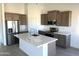 Modern kitchen featuring stainless steel appliances, an island, and stylish cabinetry at 5937 N Nigal Rd, Casa Grande, AZ 85194