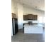 Modern kitchen featuring stainless steel appliances, an island, and stylish cabinetry at 5937 N Nigal Rd, Casa Grande, AZ 85194