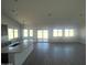 Bright living space showcasing an open layout with a kitchen and large windows at 5937 N Nigal Rd, Casa Grande, AZ 85194