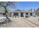 Charming single-story home with a well-manicured front yard, desert landscaping, and mature tree at 6214 W Sunnyside Dr, Glendale, AZ 85304