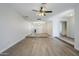 Open-concept living space featuring hardwood floors, a ceiling fan, recessed lighting, and an adjacent room at 6214 W Sunnyside Dr, Glendale, AZ 85304