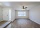 Bright living room with hardwood floors, a ceiling fan, and a large window overlooking the front yard at 6214 W Sunnyside Dr, Glendale, AZ 85304