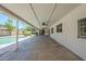Long covered patio overlooking backyard pool and manicured lawn at 6214 W Sunnyside Dr, Glendale, AZ 85304