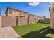 Backyard with artificial turf, brick wall fence, and a paved walkway at 6337 W Valencia Dr, Laveen, AZ 85339