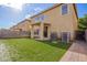 Backyard with lush, green artificial turf, covered patio, and privacy at 6337 W Valencia Dr, Laveen, AZ 85339