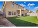 A sprawling backyard with green artificial grass and a covered patio at 6337 W Valencia Dr, Laveen, AZ 85339