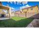 Large backyard with privacy fence and artificial turf, perfect for relaxing at 6337 W Valencia Dr, Laveen, AZ 85339