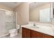 Bathroom featuring a shower and bathtub combination, toilet, sink and cabinet at 6337 W Valencia Dr, Laveen, AZ 85339