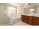 Bathroom features double sinks, soaking tub, separate shower and large window at 6337 W Valencia Dr, Laveen, AZ 85339