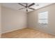 This bedroom has wood floors, a ceiling fan, and a bright window at 6337 W Valencia Dr, Laveen, AZ 85339
