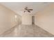 Spacious bedroom featuring neutral tones, tile flooring and a ceiling fan for optimal comfort at 6337 W Valencia Dr, Laveen, AZ 85339