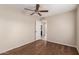 Bedroom boasts wood floors, ceiling fan, and ensuite bathroom access for added privacy at 6337 W Valencia Dr, Laveen, AZ 85339