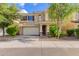 Charming two-story home featuring a neutral color scheme, tile roof, and a well-maintained front yard with mature trees at 6337 W Valencia Dr, Laveen, AZ 85339