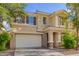 Charming two-story home featuring a neutral color scheme, tile roof, and a well-maintained front yard with mature trees at 6337 W Valencia Dr, Laveen, AZ 85339
