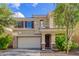 Charming two-story home featuring a neutral color scheme, tile roof, and a well-maintained front yard with mature trees at 6337 W Valencia Dr, Laveen, AZ 85339
